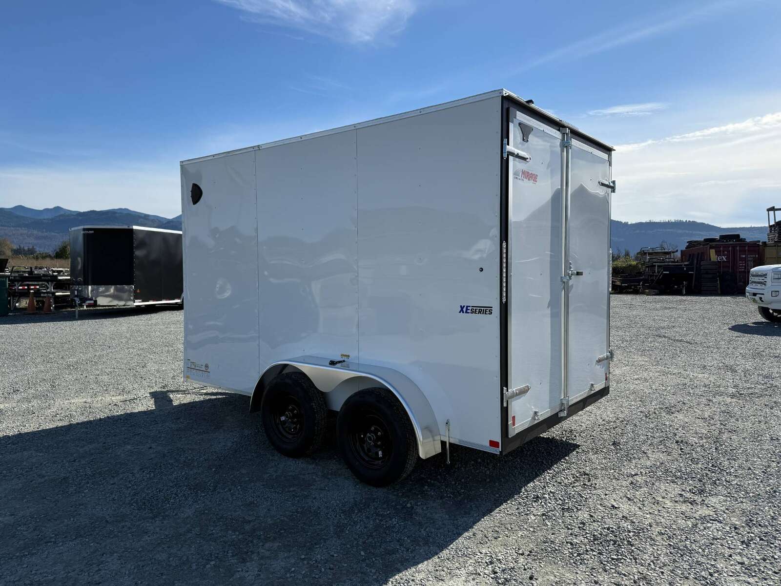 Photo of 2025 Mirage Trailers XE 7x12 V Nose Cargo / Enclosed Trailer Tandem Axle Extra Height Rear Barn Doors White 7000lb GVW