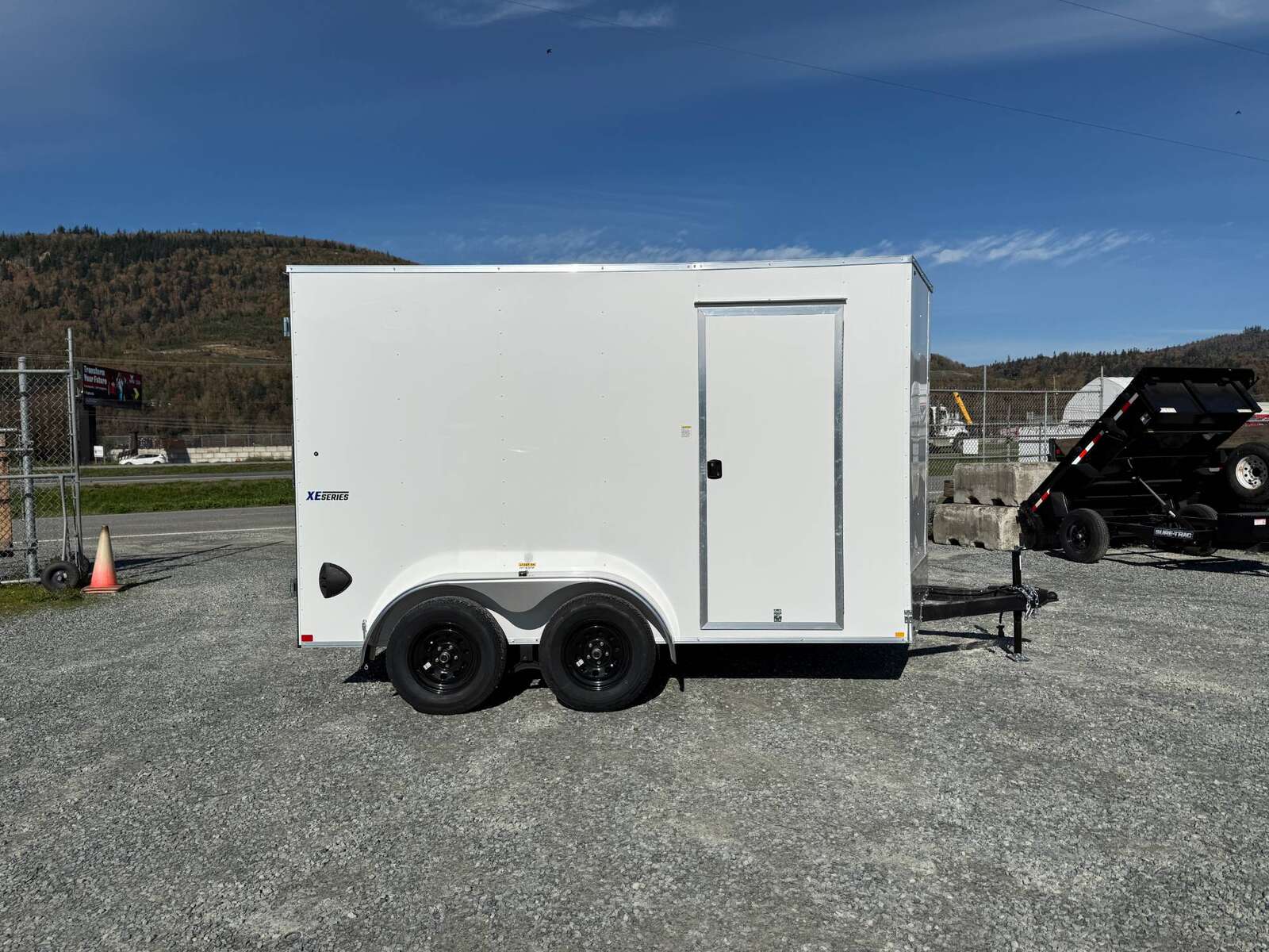 Photo of 2025 Mirage Trailers XE 7x12 V Nose Cargo / Enclosed Trailer Tandem Axle Extra Height Rear Barn Doors White 7000lb GVW
