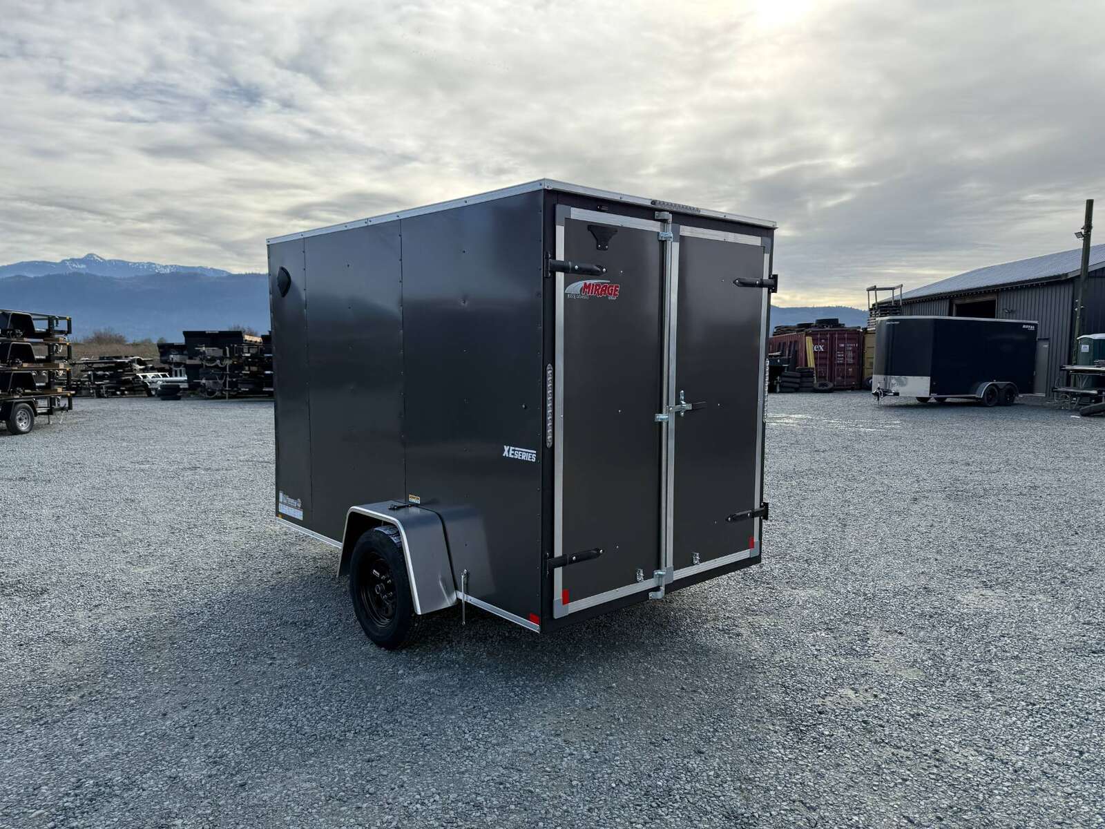 Photo of 2025 Mirage XE 6x10 V Nose Enclosed Cargo Trailer Barn Doors Charcoal Grey Extra Height 2990lb GVW